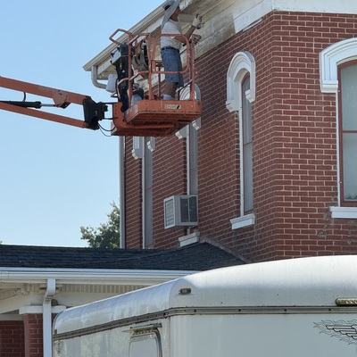 Painting trim on historic sheriff's residence
